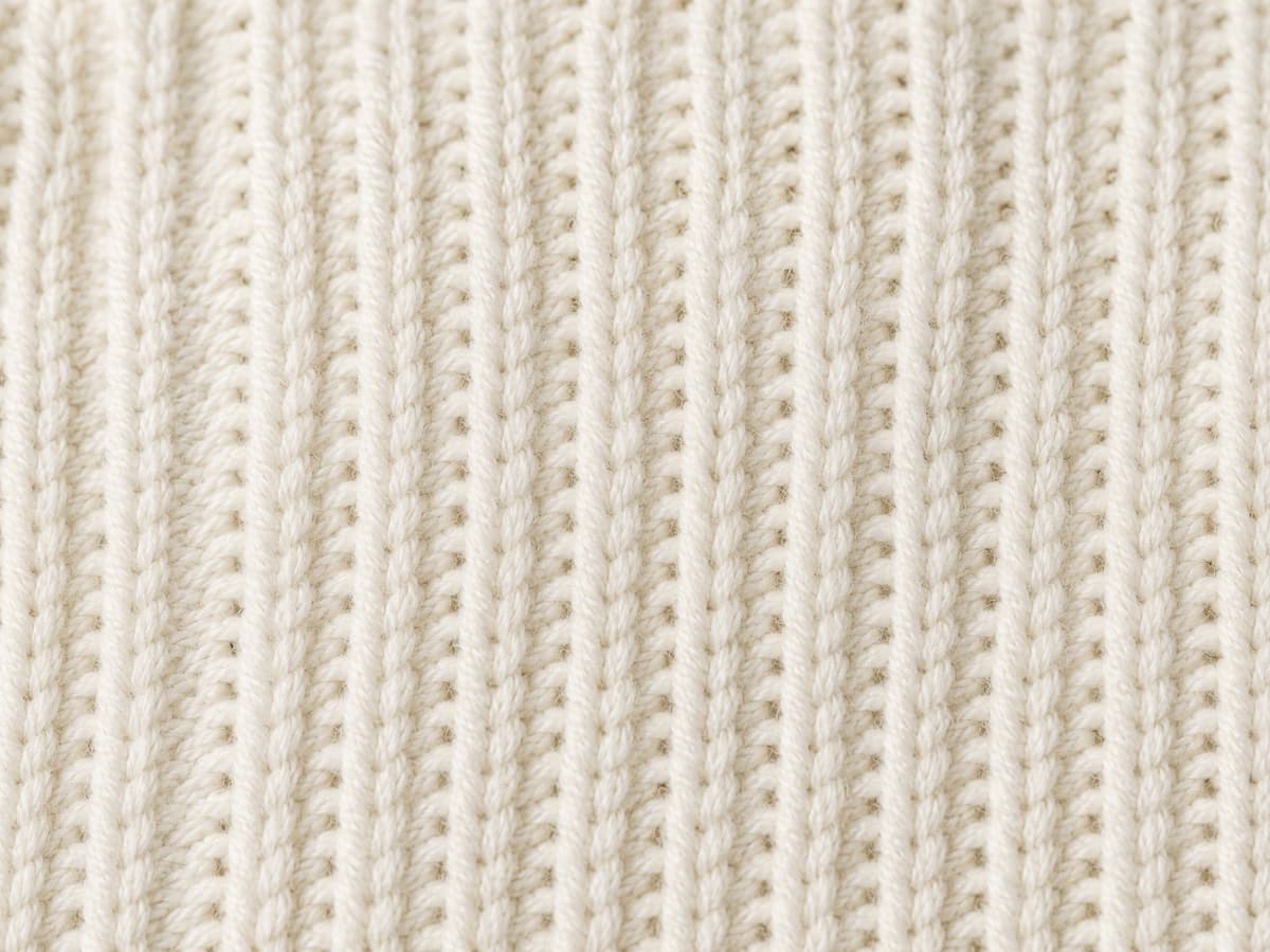 Close-up of ribbed cotton knitwear fabric texture.