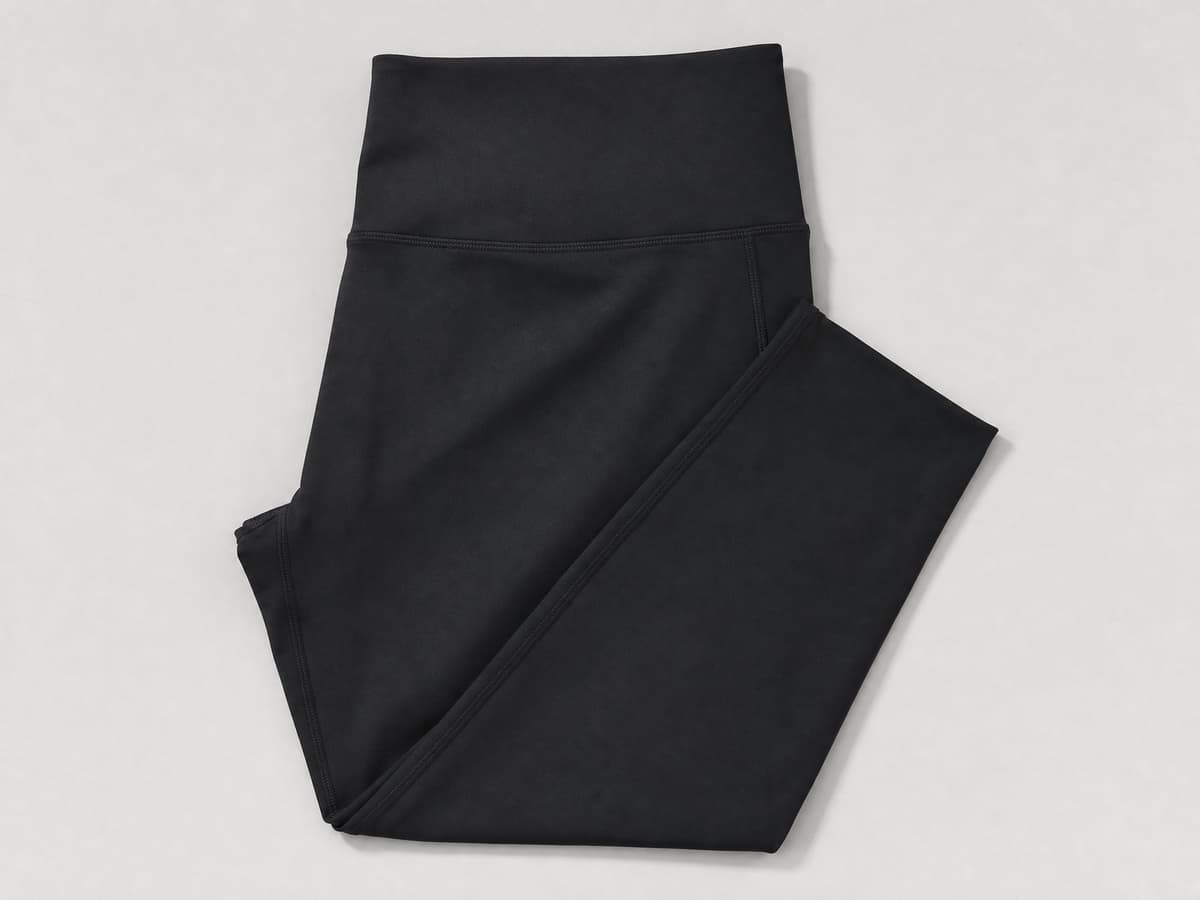 Matte black custom activewear leggings, flat-lay product photo.