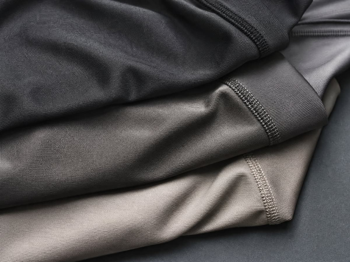 Folded technical activewear fabric with a matte performance sheen.