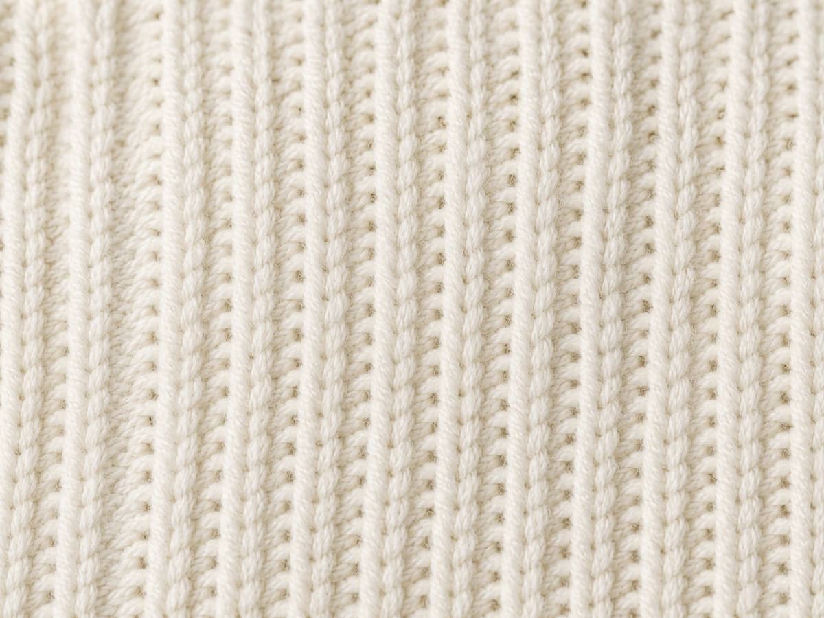 Close-up of ribbed cotton knitwear fabric texture.