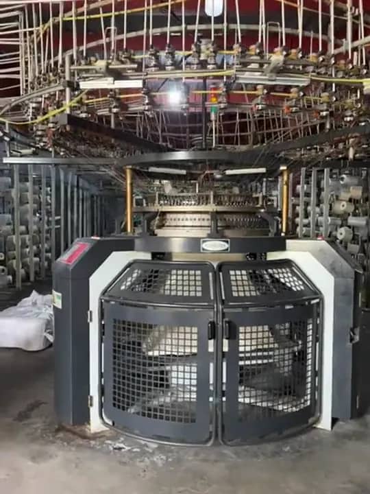 A circular knitting machine producing knit fabric at the mill Collective Studio books its cloth from.