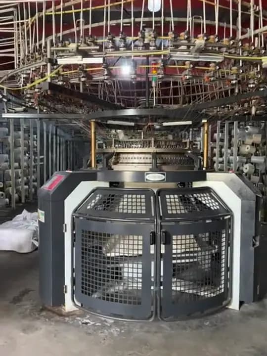 A circular knitting machine producing knit fabric at the mill Collective Studio books its cloth from.